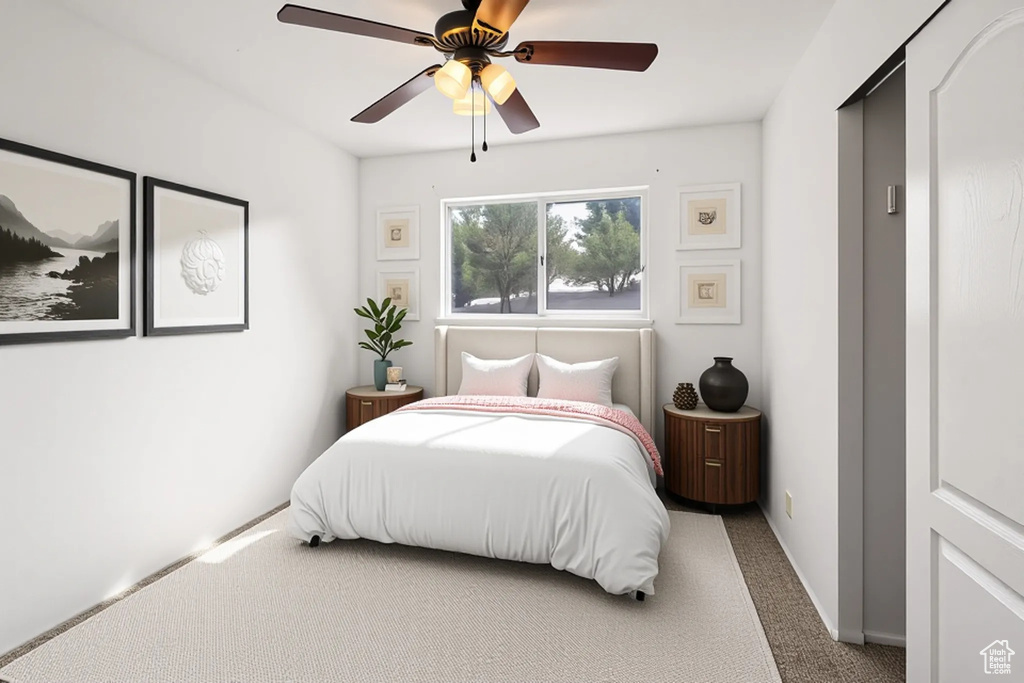 Carpeted bedroom with ceiling fan