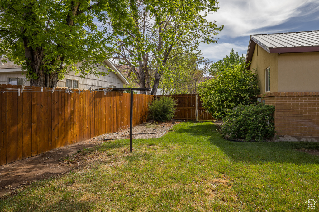 View of yard featuring fence