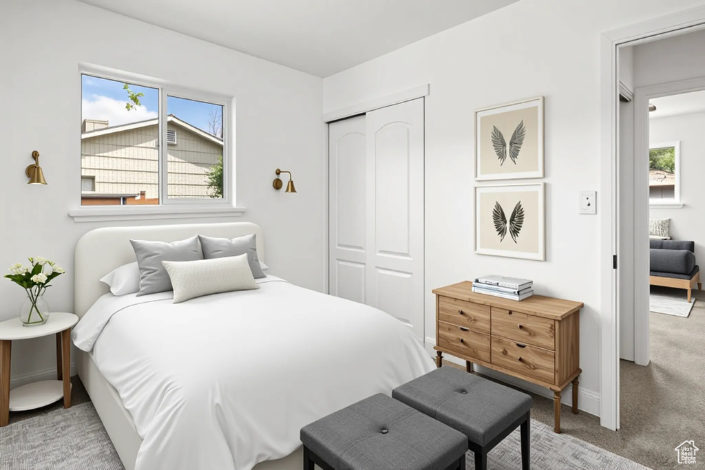 Bedroom with a closet and light colored carpet