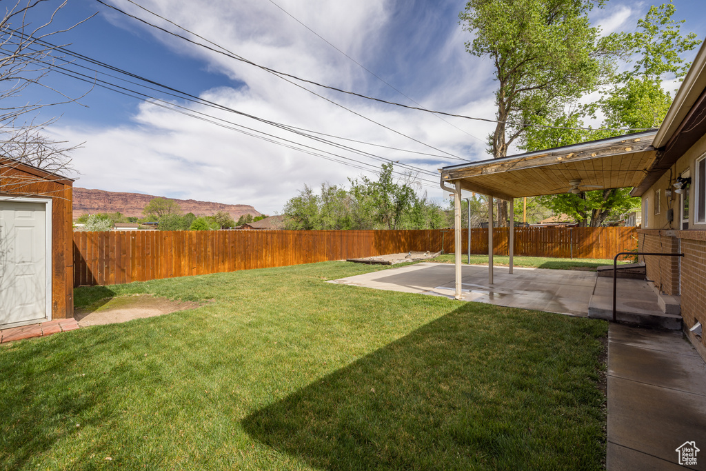 View of yard with a fenced backyard and a patio