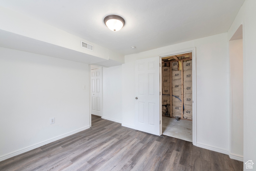 Unfurnished bedroom featuring hardwood / wood-style flooring and a closet