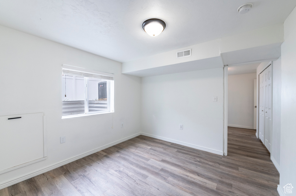 Empty room with hardwood / wood-style flooring