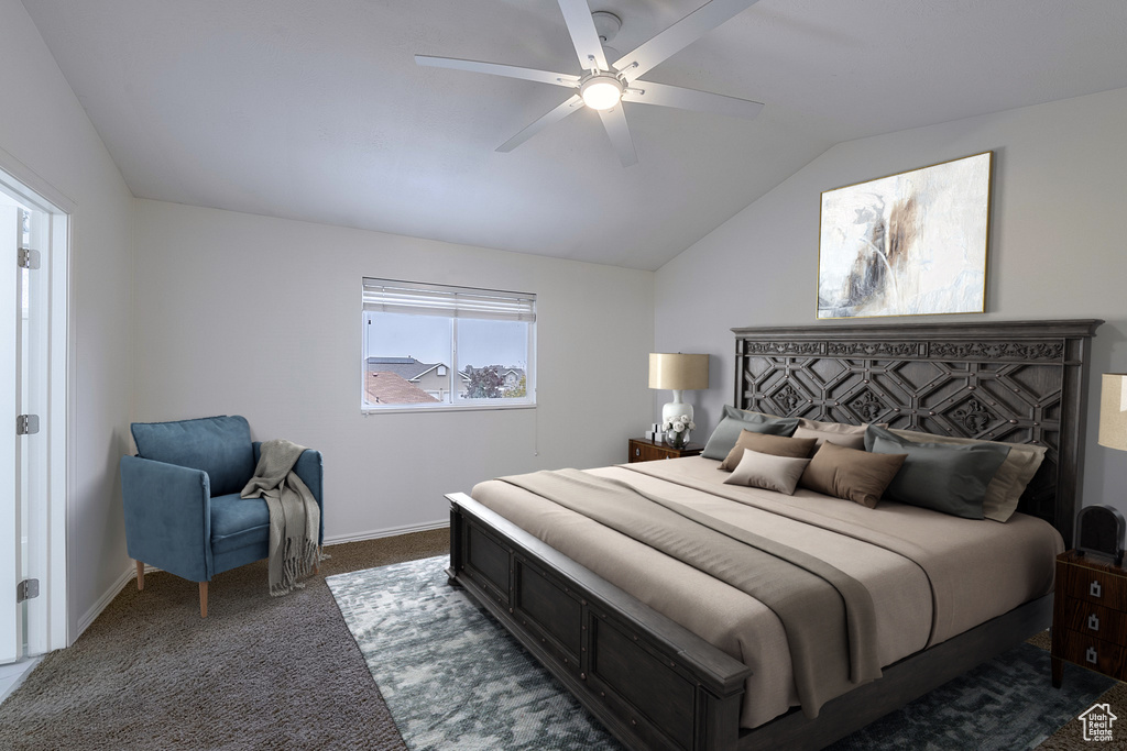 Carpeted bedroom with lofted ceiling and ceiling fan