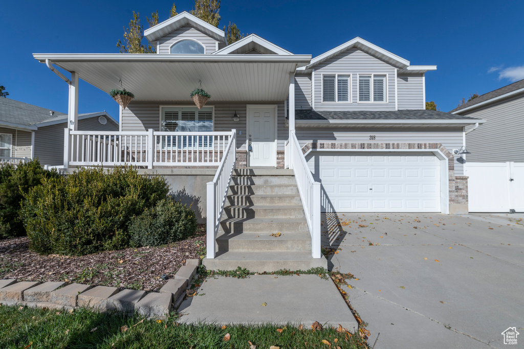 View of front of home with a garage and covered porch