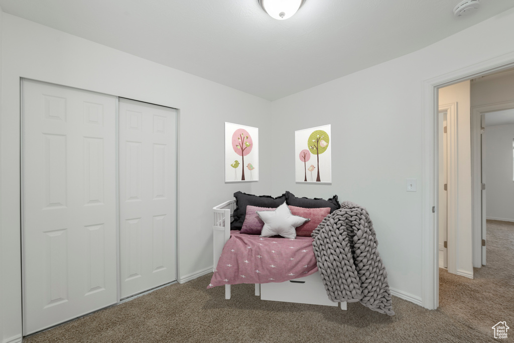 Bedroom with carpet flooring and a closet