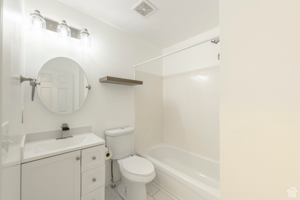 Full bathroom featuring tile patterned flooring, vanity, toilet, and shower / bathtub combination