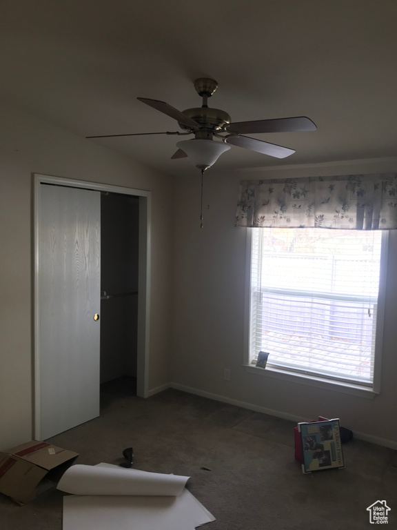 Unfurnished bedroom with a closet, carpet flooring, and ceiling fan