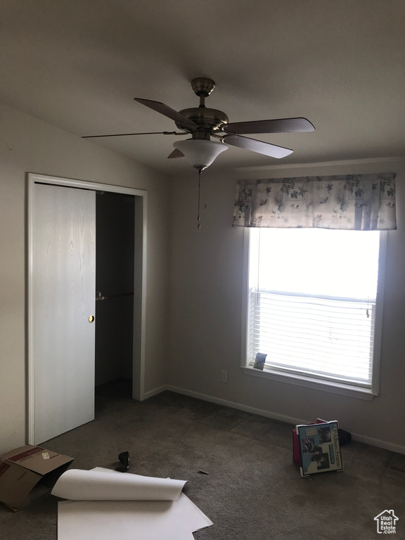 Unfurnished bedroom with a closet, carpet flooring, and ceiling fan