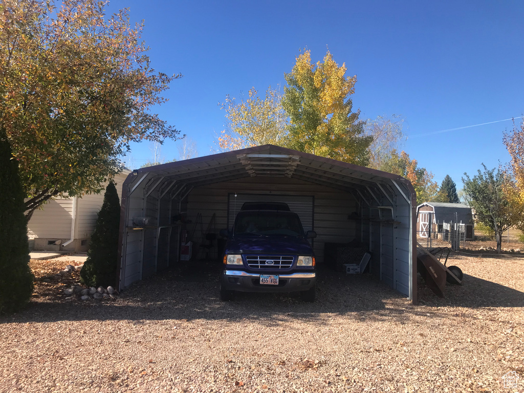 View of outbuilding featuring a carport