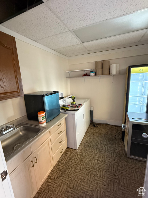 Laundry area with cabinets, sink, and washer and clothes dryer