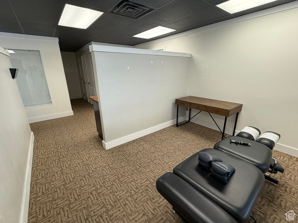 Exercise area with a drop ceiling and carpet