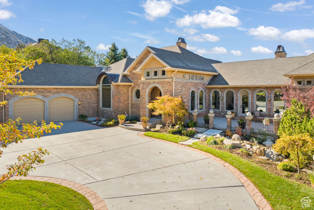 View of front of property featuring a garage and a mountain view