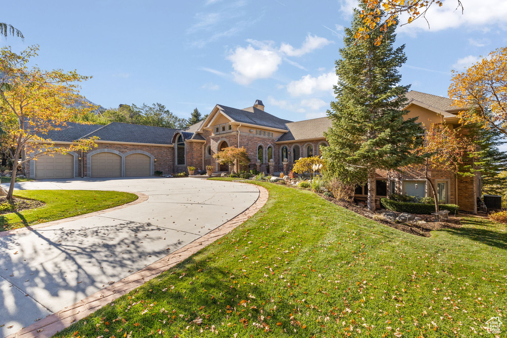 View of front of home featuring a garage and a front yard