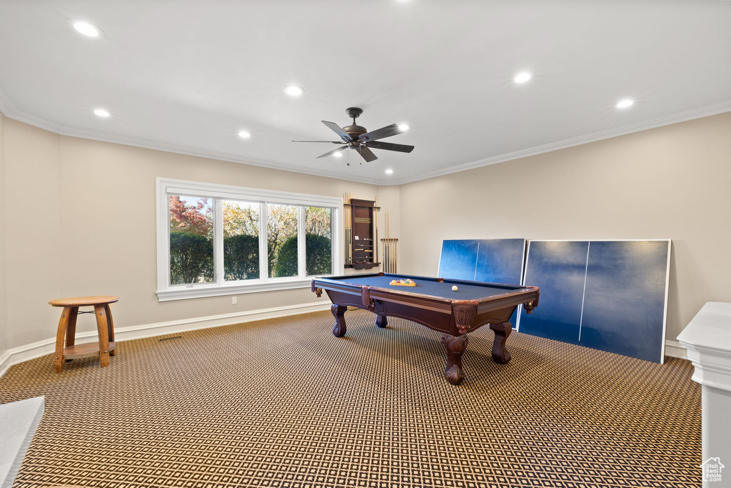 Game room with ceiling fan, ornamental molding, billiards, and carpet