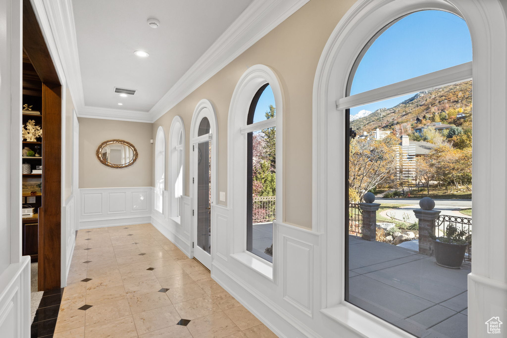 Doorway to outside featuring ornamental molding