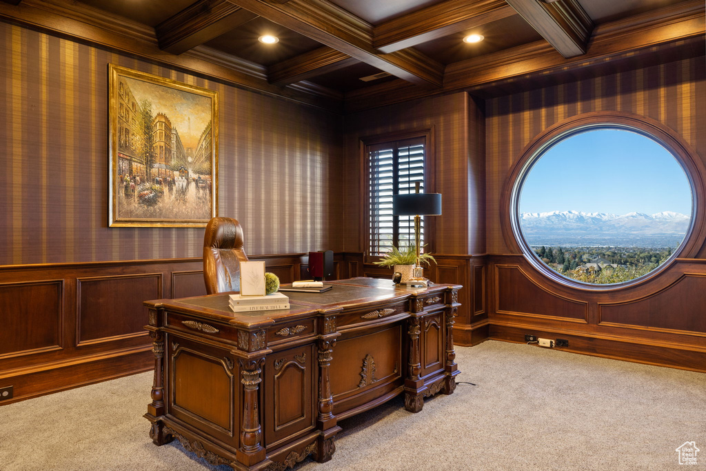 Office area with coffered ceiling, light colored carpet, ornamental molding, and beam ceiling