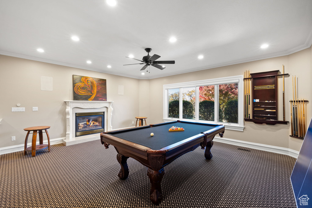 Game room featuring ceiling fan, dark colored carpet, billiards, and ornamental molding