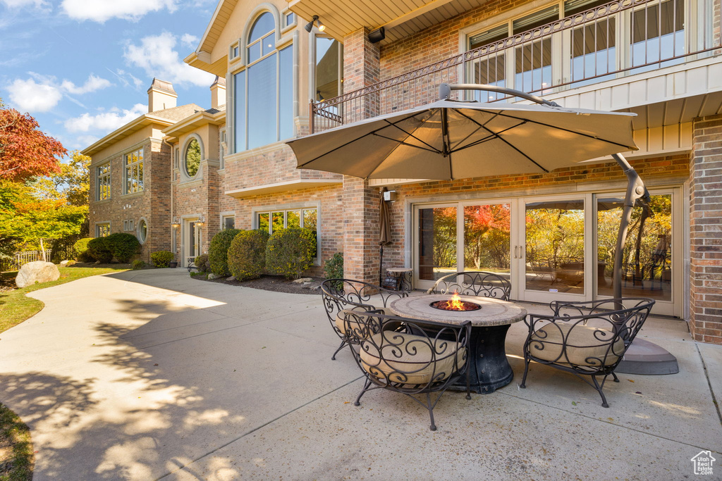 View of patio / terrace with a balcony and an outdoor fire pit