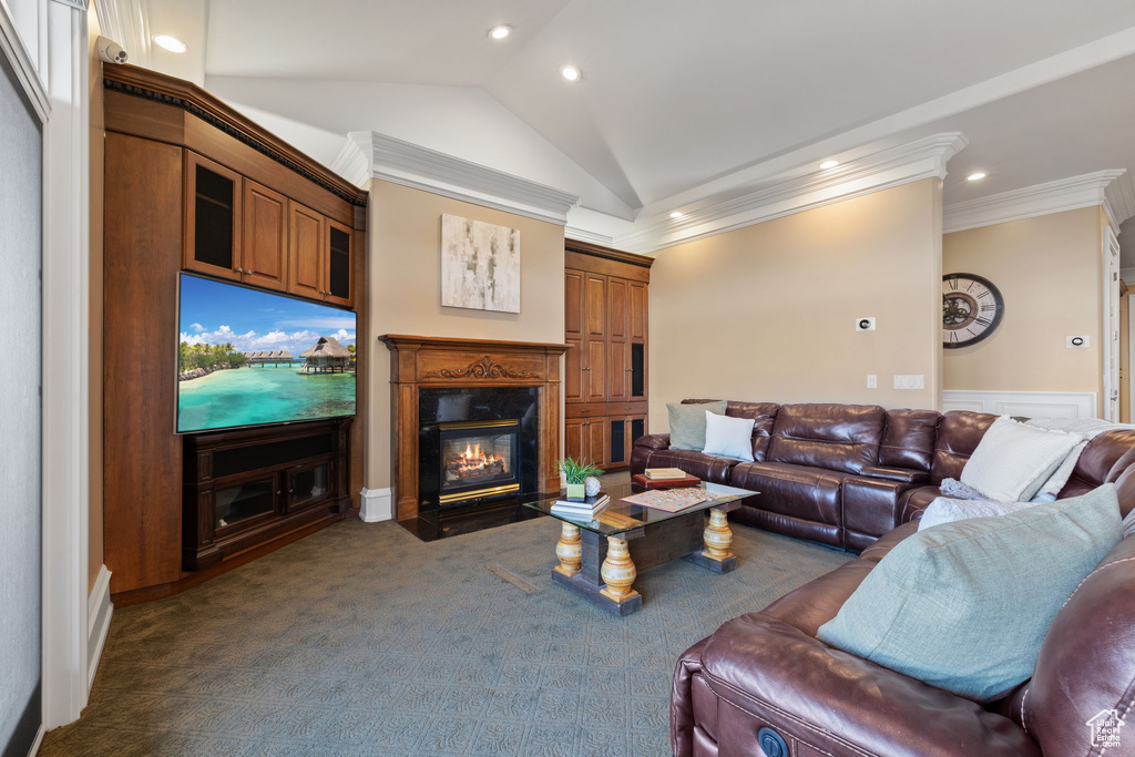 Living room featuring lofted ceiling, dark carpet, and crown molding