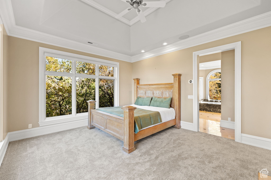 Bedroom with ornamental molding, light colored carpet, and ceiling fan