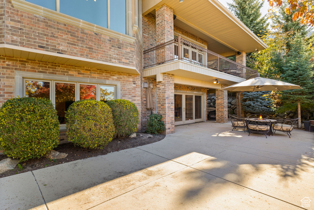 Back of property featuring a patio area and a balcony