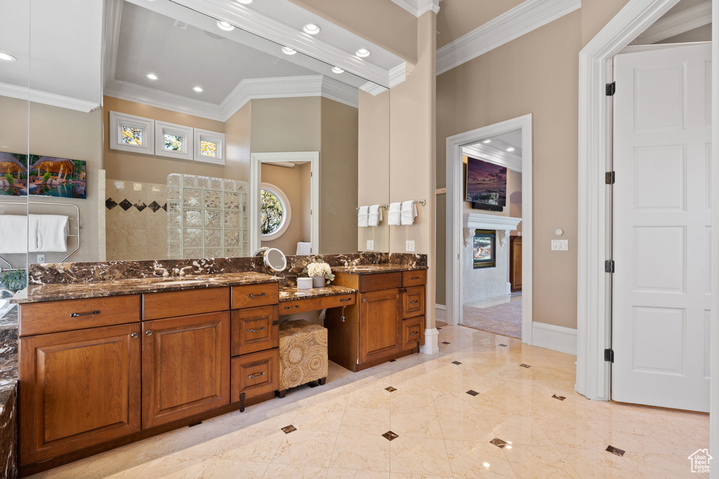 Bathroom featuring vanity and ornamental molding