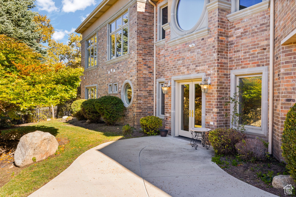 Doorway to property featuring a patio area