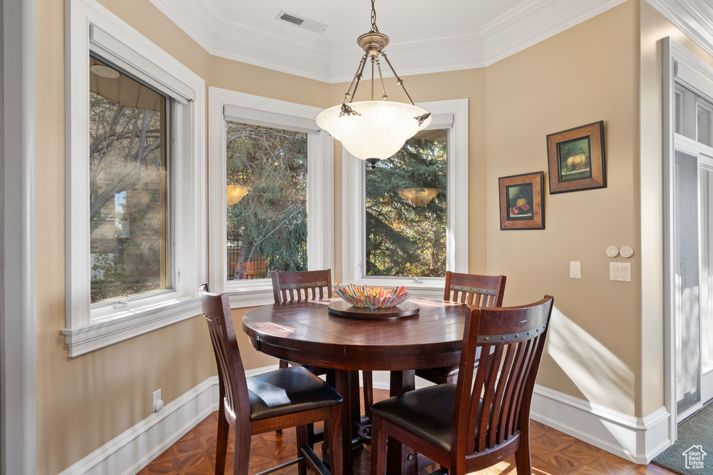 Dining space featuring ornamental molding