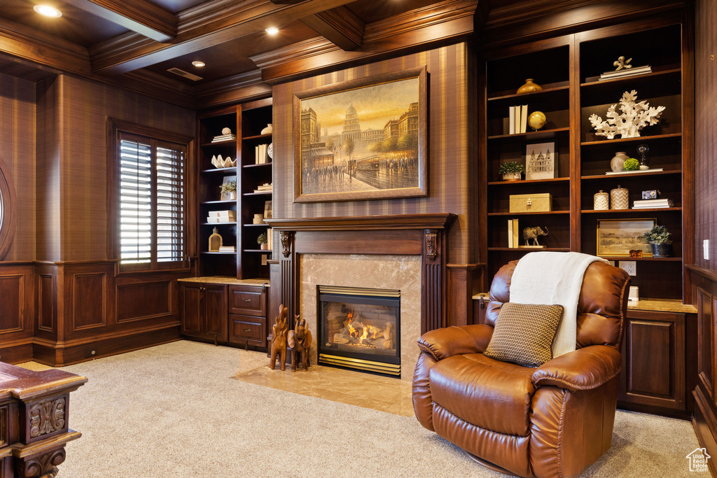 Living area featuring wooden walls, light carpet, and coffered ceiling