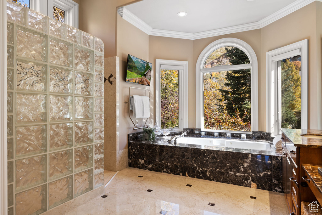 Bathroom featuring plus walk in shower and ornamental molding