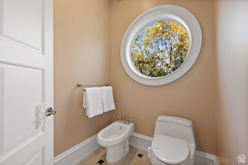 Bathroom featuring a bidet, tile patterned floors, and toilet