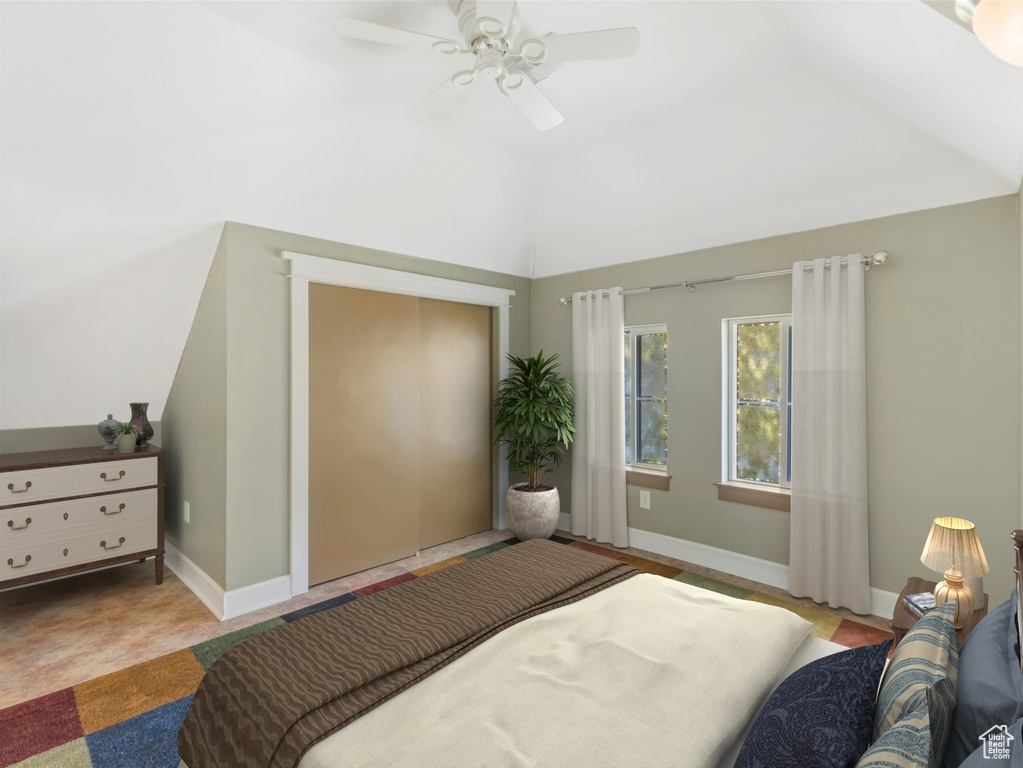 Bedroom with baseboards, vaulted ceiling, and a ceiling fan