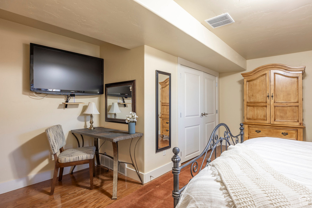 Bedroom with dark wood-type flooring