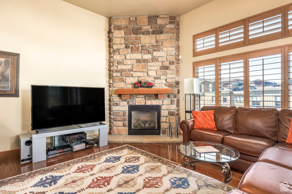 Living room featuring dark hardwood / wood-style floors and a fireplace