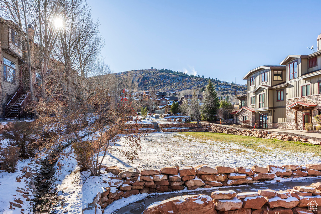 Snowy yard featuring a mountain view