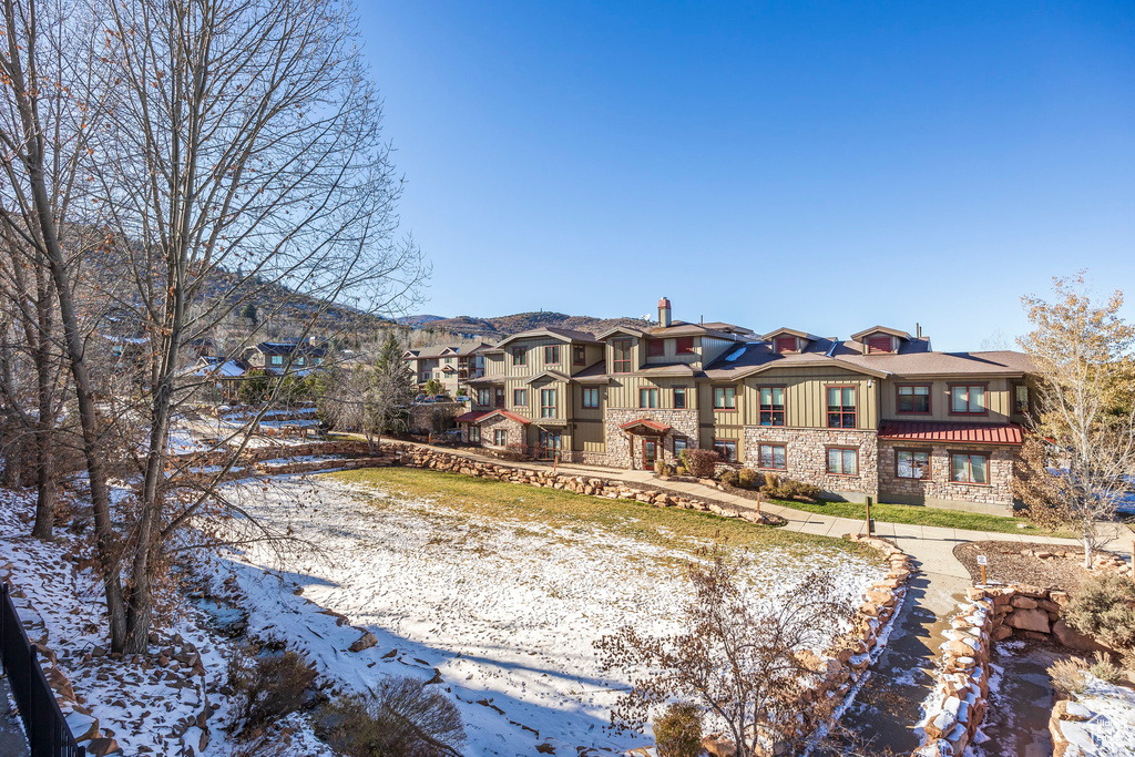 Snow covered property with a balcony