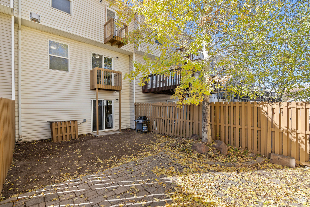 Rear view of property with a patio and a balcony