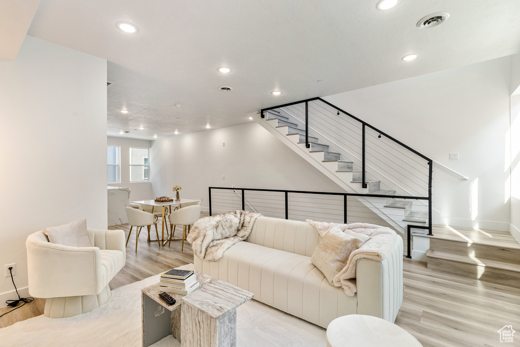 Living room with light hardwood / wood-style floors