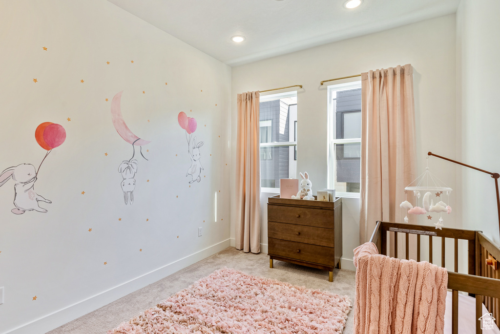 Bedroom featuring light colored carpet