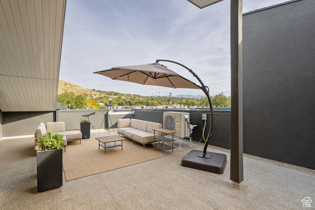 View of patio with a mountain view and an outdoor living space