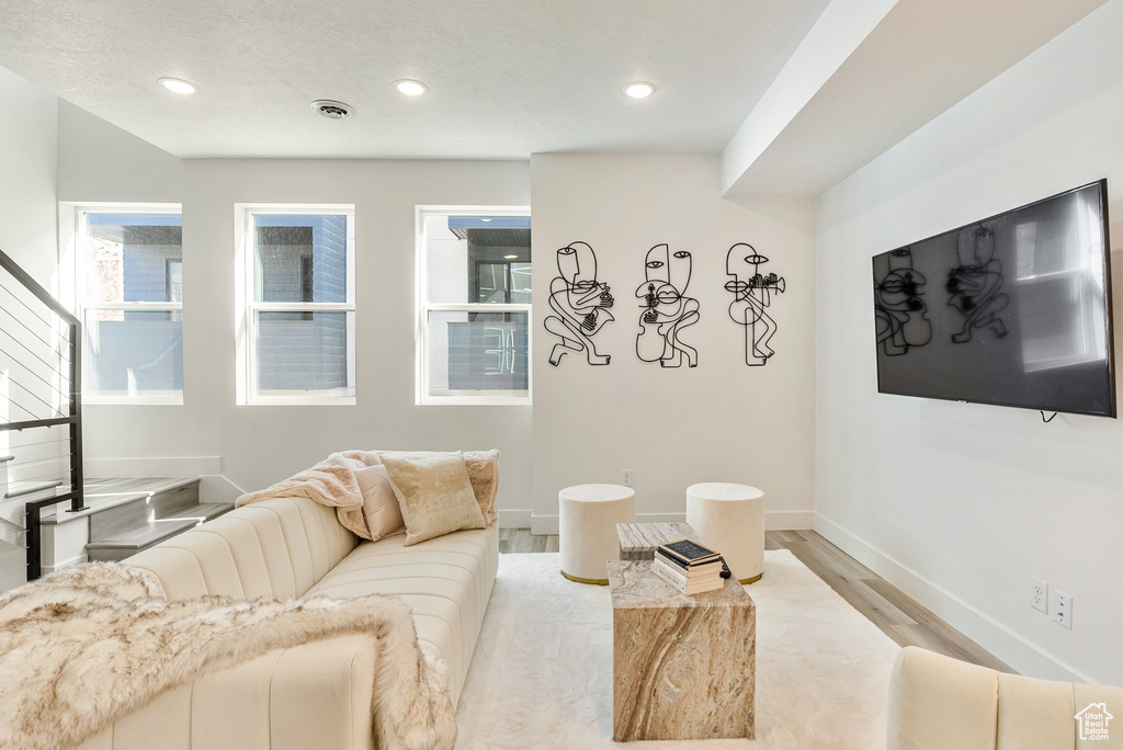 Living room with light hardwood / wood-style flooring