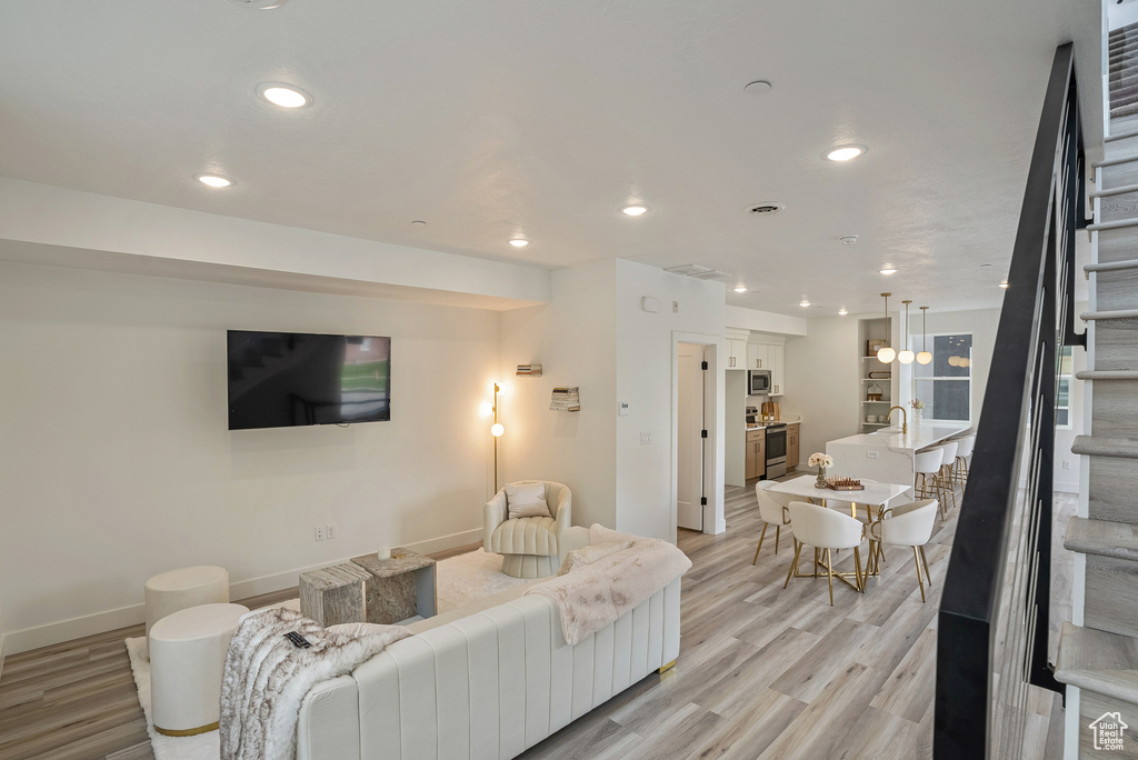 Living room with light hardwood / wood-style flooring