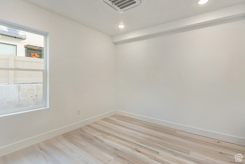 Empty room with light hardwood / wood-style floors