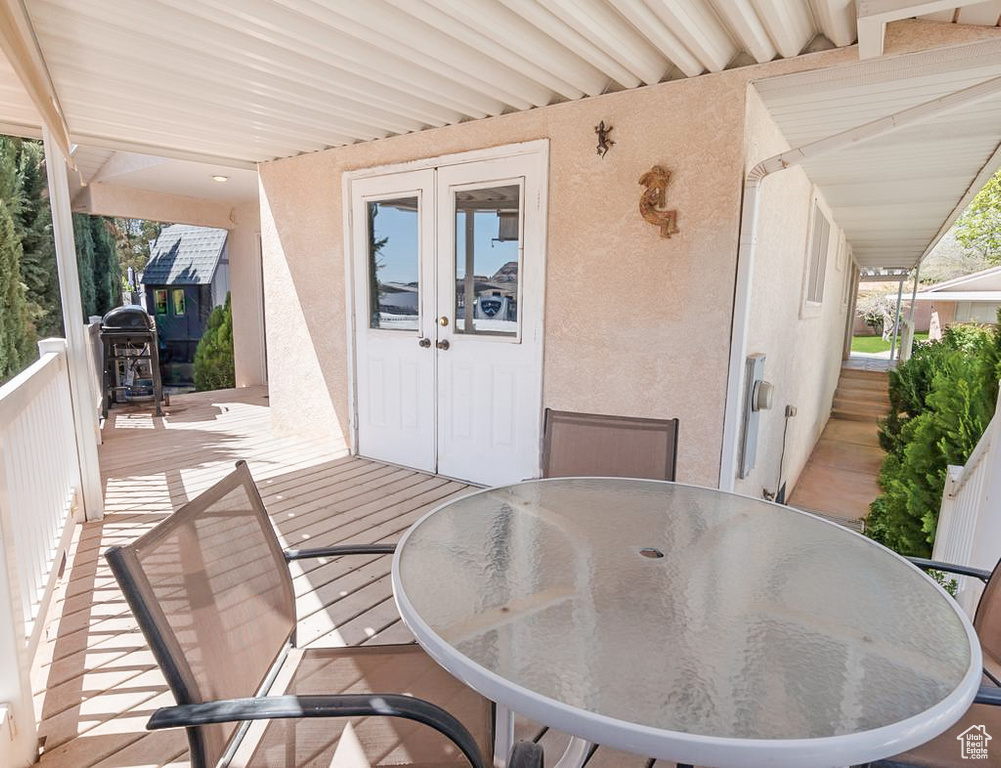 Exterior space with outdoor dining area, french doors, and a wooden deck