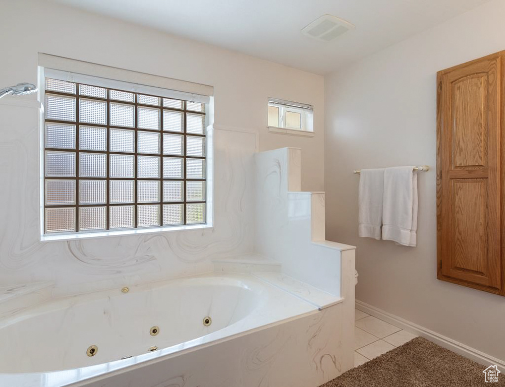 Full bath with tile patterned flooring, a jetted tub, and visible vents