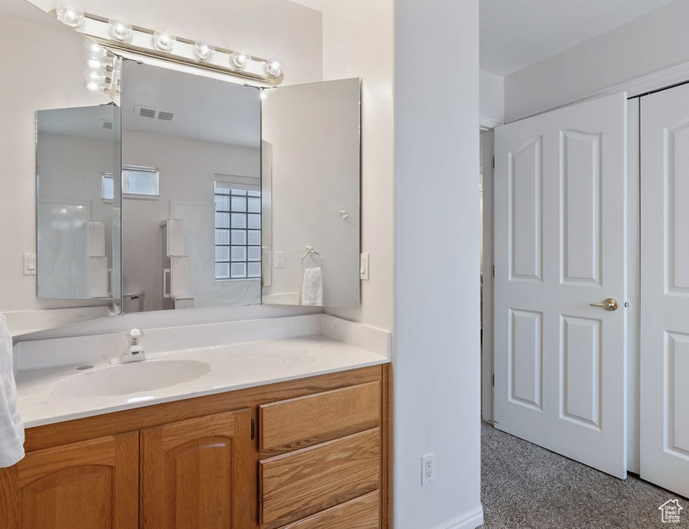 Bathroom with vanity and visible vents