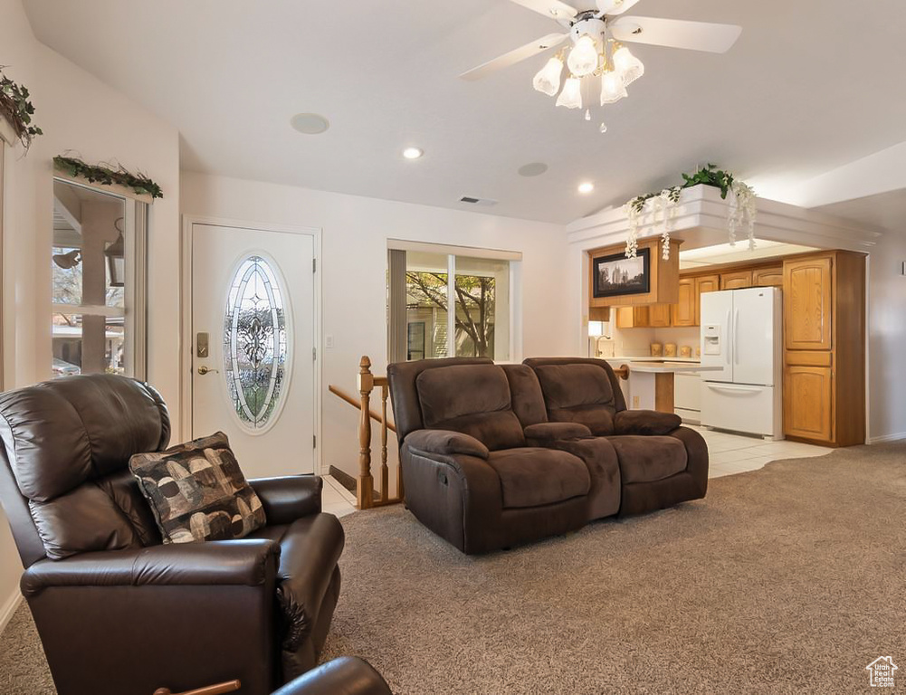 Living area with baseboards, recessed lighting, light colored carpet, and a ceiling fan