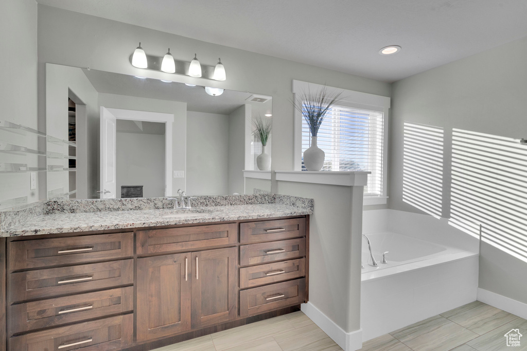 Bathroom with vanity and a tub