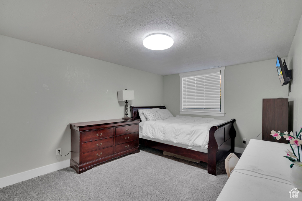 Carpeted bedroom with a textured ceiling