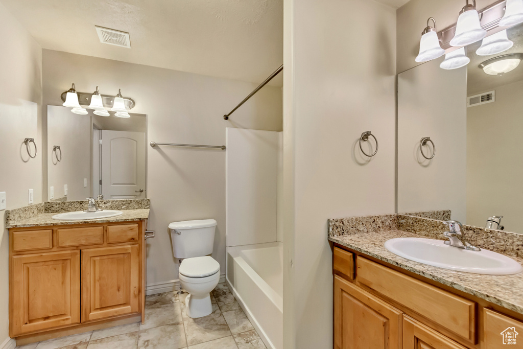 Full bathroom with vanity, bathing tub / shower combination, and toilet